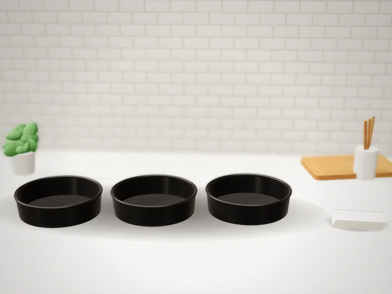 8 Inch Round Cake Pan 3-Piece Nonstick Set with 100 Parchment Rounds in a home kitchen
